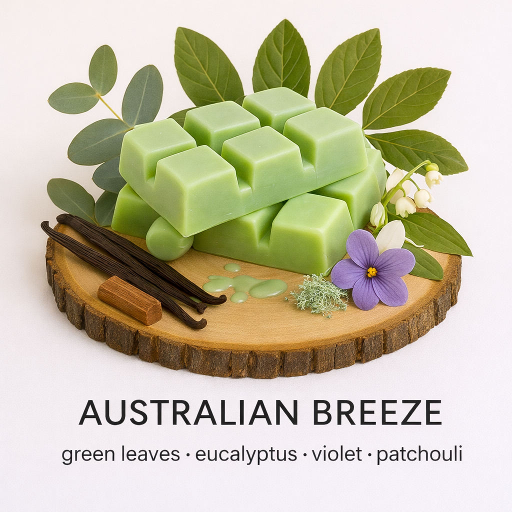 Green wax melts with leaves, eucalyptus, violet, and patchouli on a wooden board with a white background. Australian Breeze by Fair Dinkum Scents