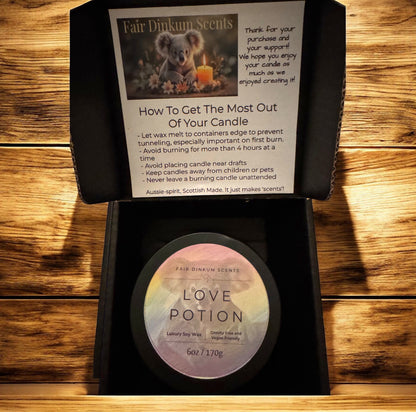 Inside view of box showing stylish black tin, lid, and label align with candle care card. 