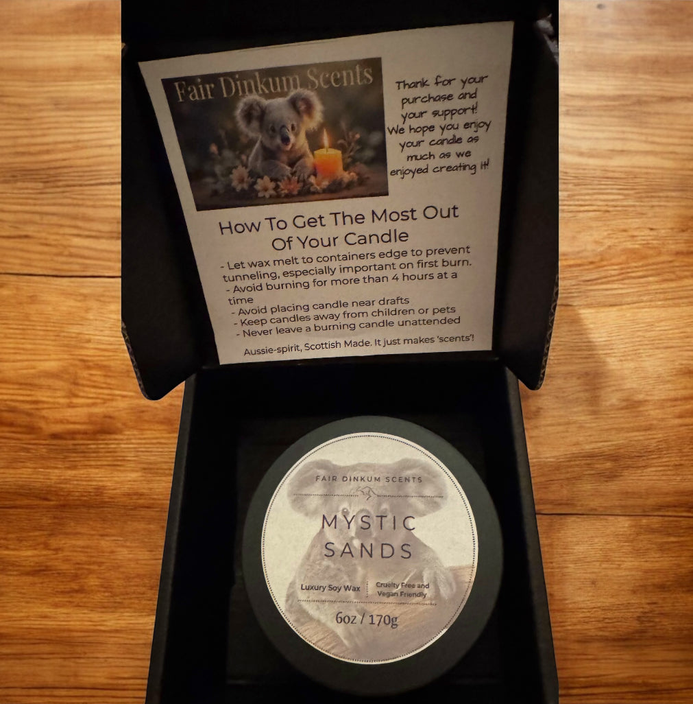 Inside view of box showing stylish black tin, lid and label. As well as candle care card. 