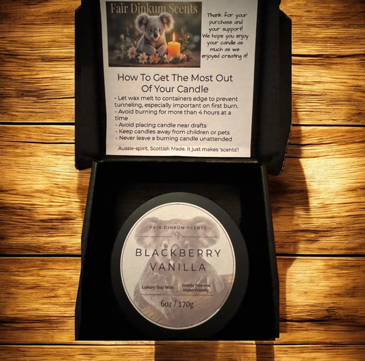 Blackberry Vanilla candle in a box with a label on a wooden surface