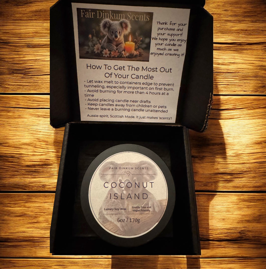 Coconut Island candle in a black box with instructions on a wooden surface