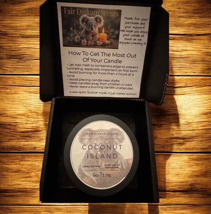 Coconut Island candle in a black box with instructions on a wooden surface