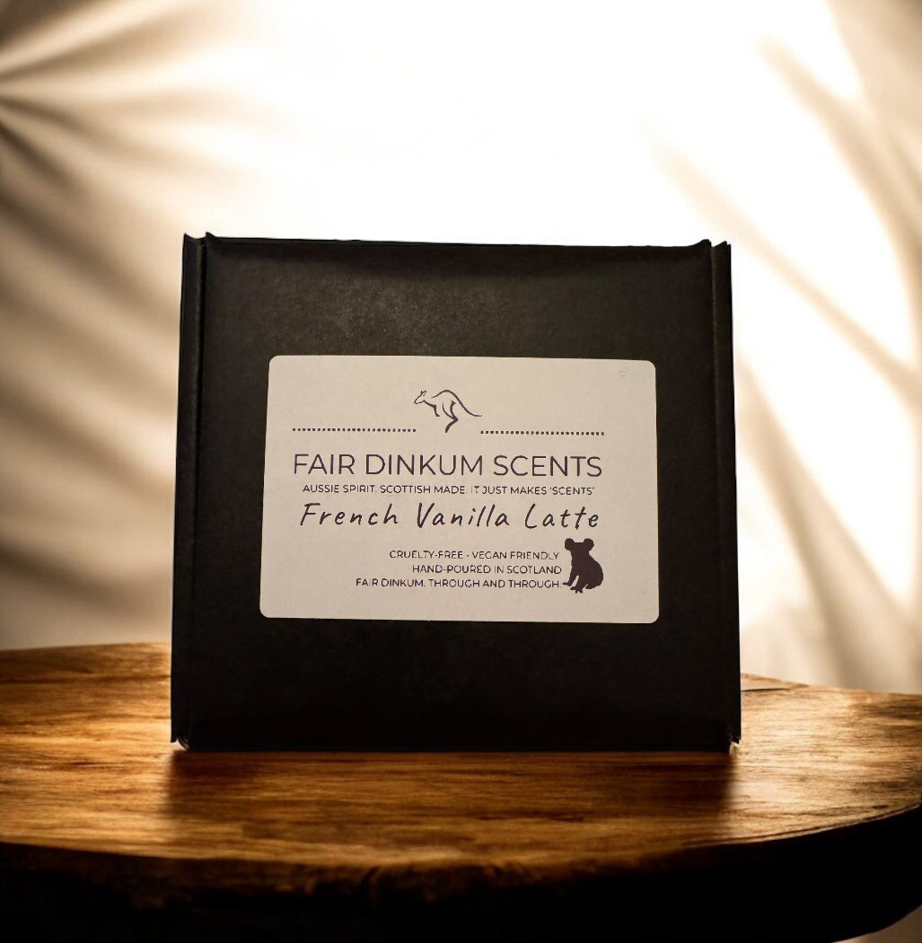 Black packaging of Fair Dinkum Scents French Vanilla Latte on a wooden surface with a soft light background