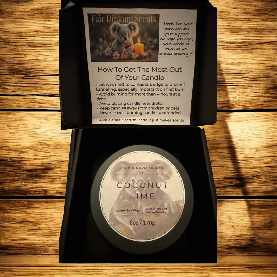 Coconut Lime candle in a black box with instructions on a wooden surface