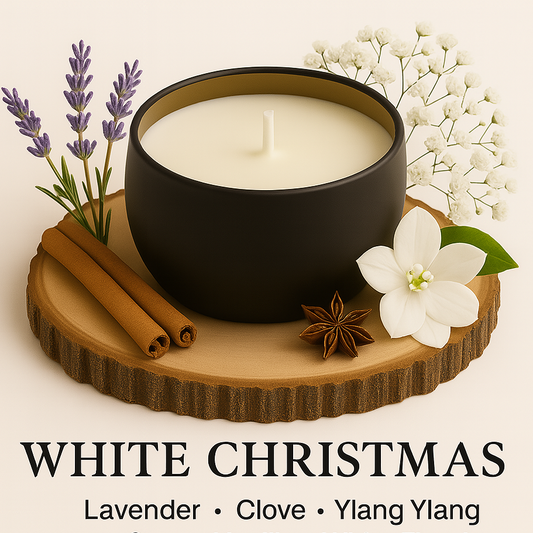 Black candle on a wooden coaster with flowers and spices, labeled 'White Christmas'.